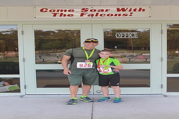 Father Jim and son Asher Ravede together before a race.