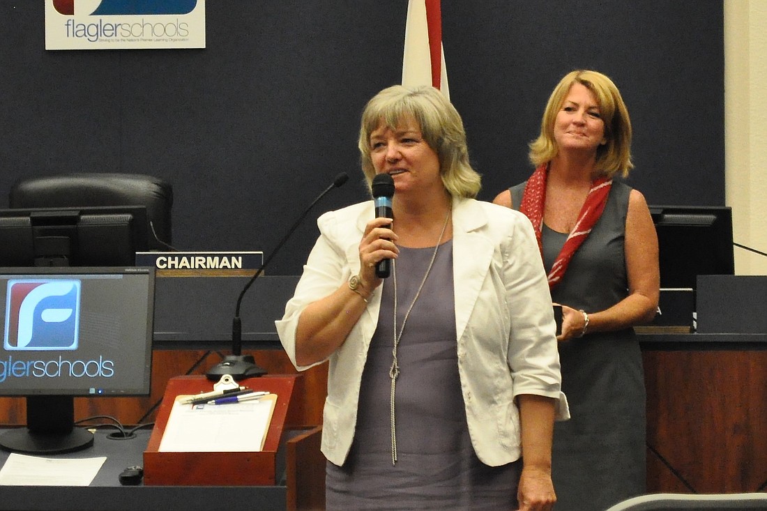 Flagler Palm Coast High School Principal Lynette Shott, who is moving from her position at FPC to one in administration this year, with School Board member Colleen Conklin at a board meeting June 2. (Photo by Jonathan Simmons.)