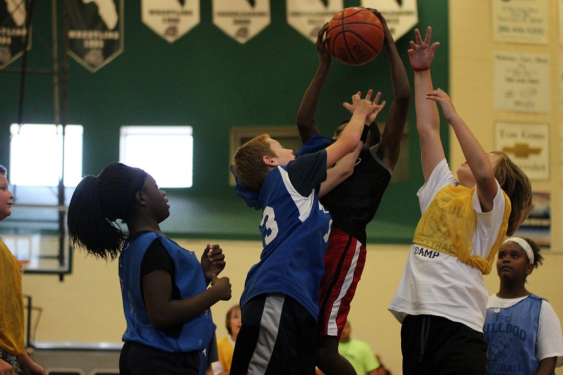 Kids fight for a rebound in the closing games of FPC basketball camp.