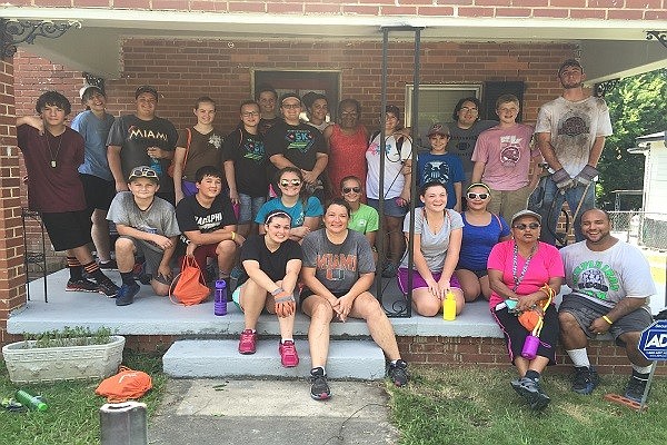 Palm Coast Community Church's youth group stands out front of a recent home worked on in Columbus, Georgia