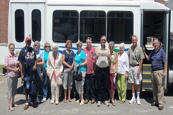 Bill Ryan stands with the audience of the bus tour on June 15