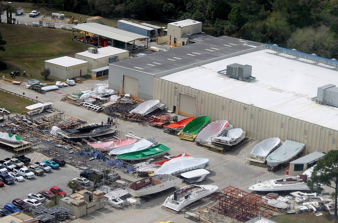 The boat manufacturing company's current parking lot is crowded with boat molds. (Courtesy photo.)