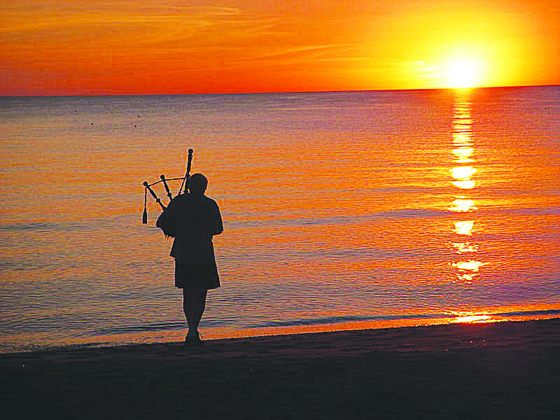 Elizabeth Ann Dohan submitted this photo of a bagpiper playing Ã¢â‚¬Å“Amazing GraceÃ¢â‚¬Â at sunset, taken near Beachplace, located in the 1100 block of Gulf of Mexico Drive.