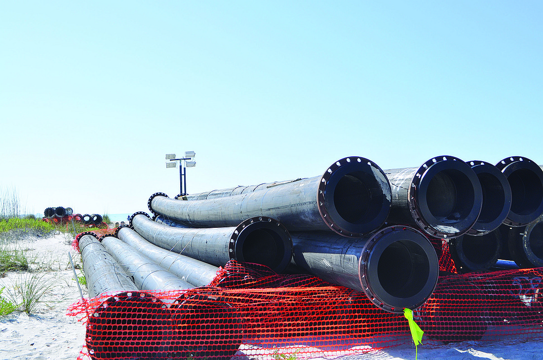 Large pipes that will be used to funnel sand onto the eroded north end of the island were placed on Beer Can Island Friday, March 18.