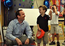 Primrose School kindergartner Cameron Phayre and his father, Scott, celebrated after learning their family had won third-prize in the Family Dance-off video contest.