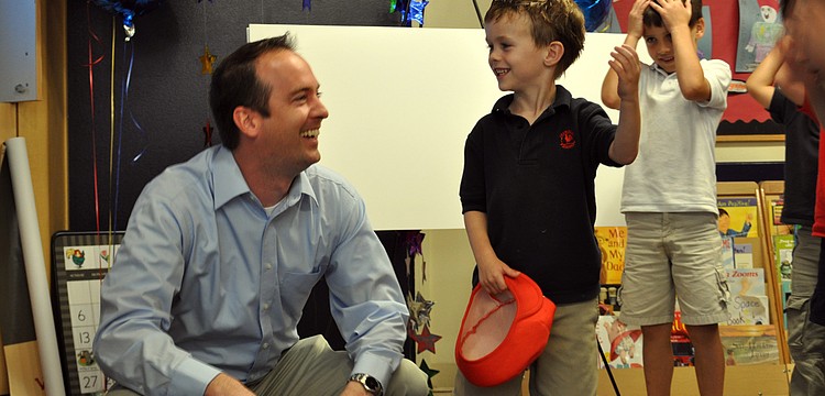 Primrose School kindergartner Cameron Phayre and his father, Scott, celebrated after learning their family had won third-prize in the Family Dance-off video contest.