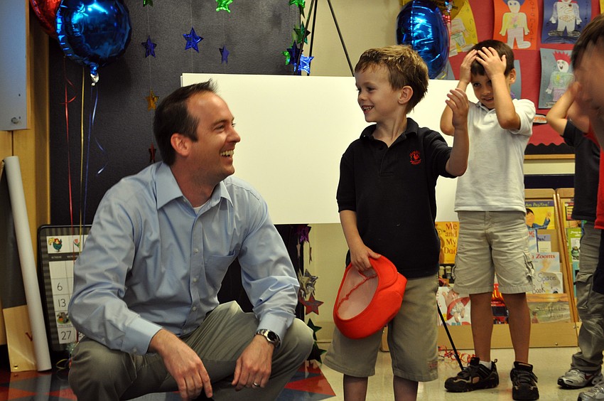 Primrose School kindergartner Cameron Phayre and his father, Scott, celebrated after learning their family had won third-prize in the Family Dance-off video contest.
