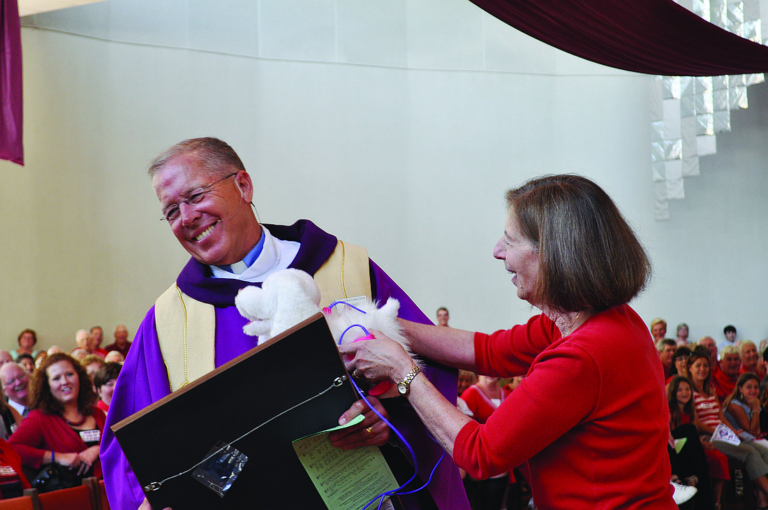 The Rev. Don Henry  receives gifts from Sister Judy Baldino Sunday, March 27. Later in the day, Henry also received another surprise gift Ã¢â‚¬â€ keys to a new Acura, a present from his parishioners.