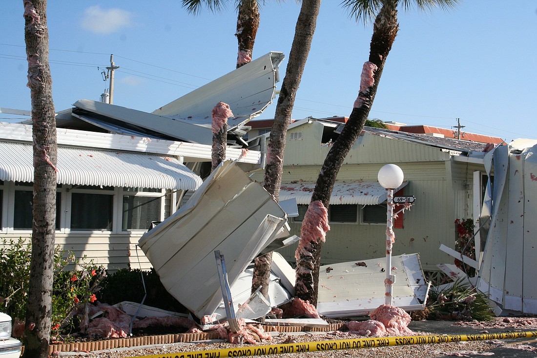 Yesterday's storm damaged mobile homes in Twin Shores Thursday. The flying metal also cut a palm tree in half.