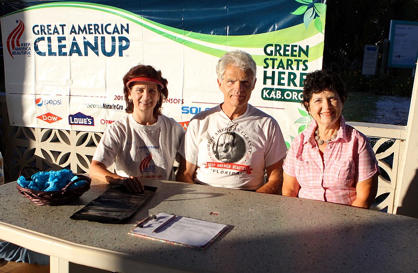 Candi and Jack Messerschmidt with Rachele Farnum worked to sign people up and hand them trash bags and blue gloves on Saturday, April 2, on Siesta Key Beach during the 2011 Great American Cleanup, part of Keep Sarasota County Beautiful.