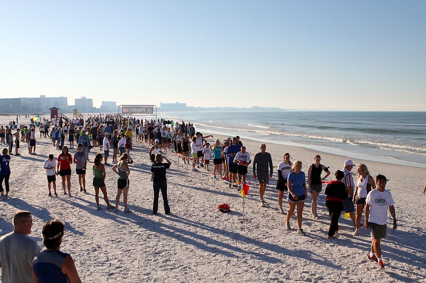 Runners make their way across the finish line and line up to get their time cards on Saturday, April 2 during the 25th Annual Run for the Turtles on Siesta Key Beach.