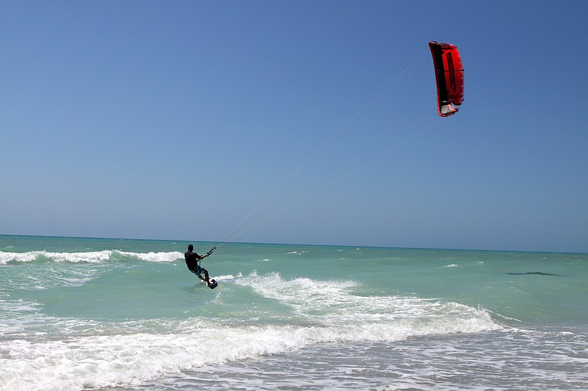 Tony Grinnell welcomed the choppy waves and wind Monday, April 4 as he kitesurfed in the Gulf of Mexico.