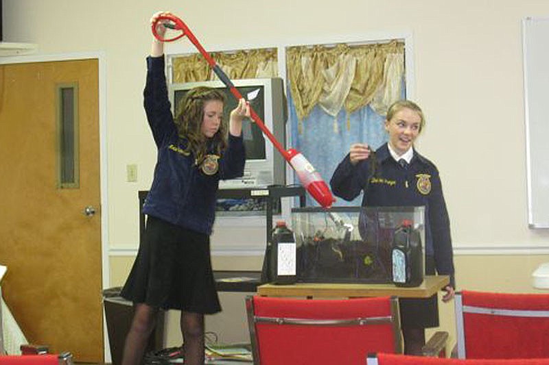 Mollie Rainwater and Brooke Troyer demonstrate their 'soil swifter' tool.