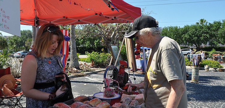 Christine Winkler packs up Barbara Stoutenburgh's purchases.