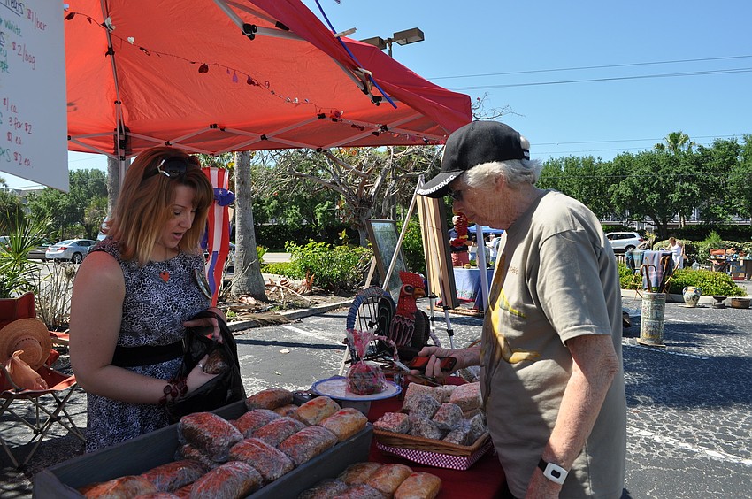 Christine Winkler packs up Barbara Stoutenburgh's purchases.