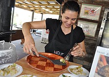 Culinary Organizer Jennifer Richter dishes out samples of a recipe featuring cabbage. Richter leads cooking demonstrations at the farm.