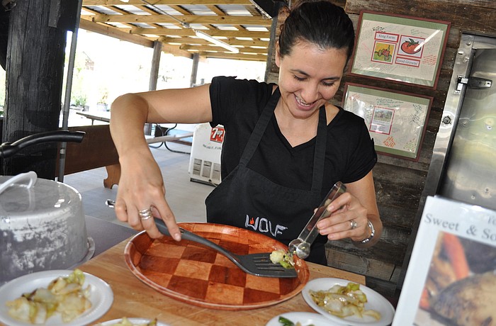 Culinary Organizer Jennifer Richter dishes out samples of a recipe featuring cabbage. Richter leads cooking demonstrations at the farm.