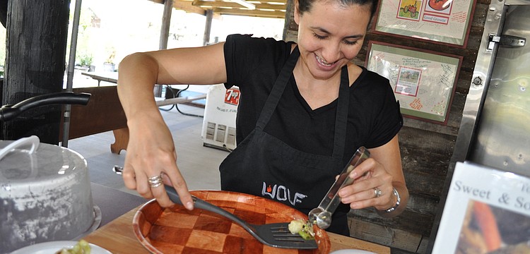 Culinary Organizer Jennifer Richter dishes out samples of a recipe featuring cabbage. Richter leads cooking demonstrations at the farm.