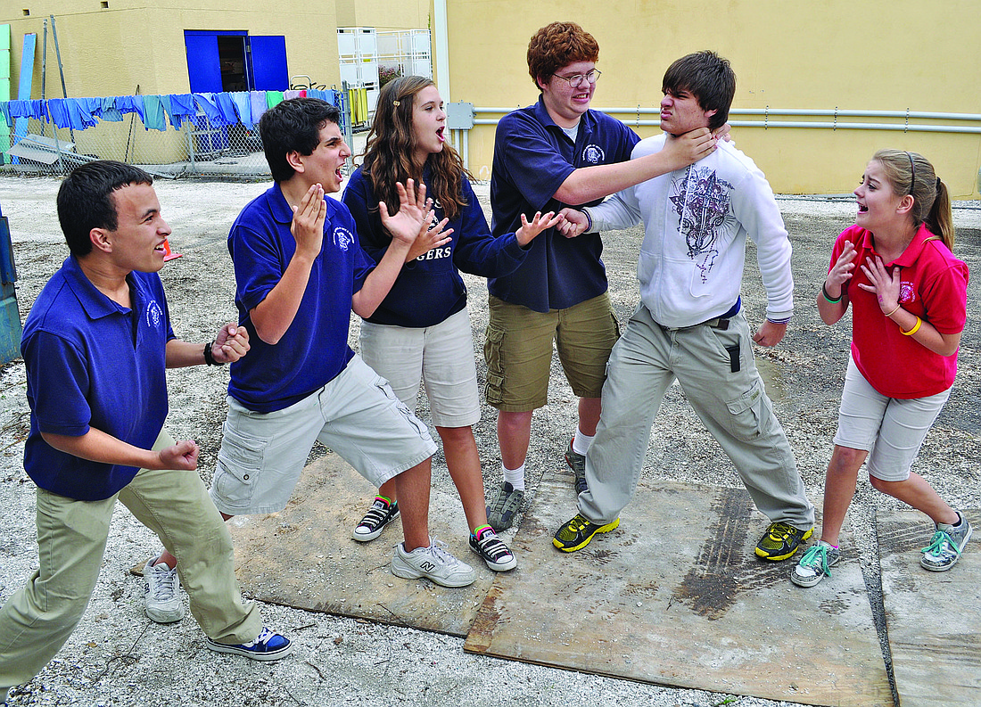 C.J. Ramsey (the Beast) and Zach Herman (Gaston), middle, act out a fight scene while Jouse Rivera (Cogsworth), Ryan OÃ¢â‚¬â„¢Dell (LumiÃƒÂ¨re), Sierra Schwabach (Mrs. Potts) and Emma Slotabec (Belle) watch.