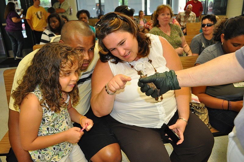 Hannaiz Nater, 6, checked out a bat with her parents Luis and Tanya.