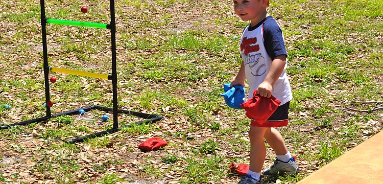 Hunter Morrison gears up to toss some beanbags during a game of cornhole.