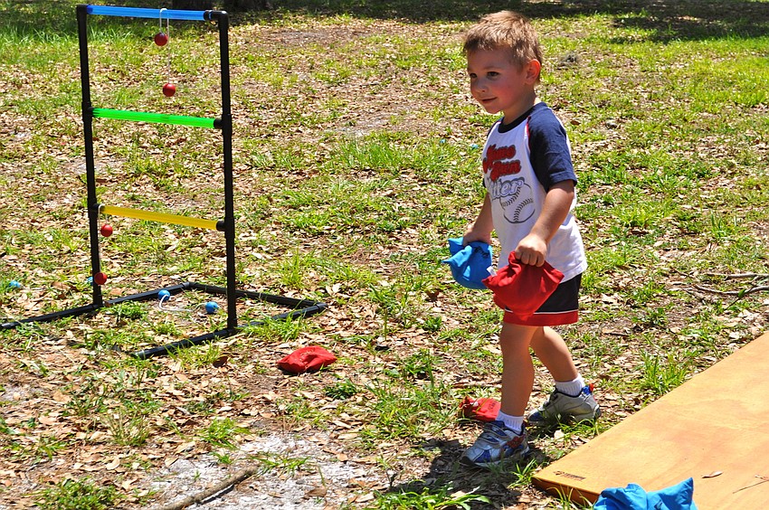 Hunter Morrison gears up to toss some beanbags during a game of cornhole.