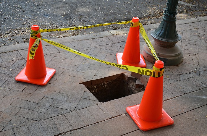 Workers are digging the holes where the parking meters will be placed.