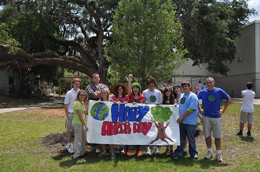 Cardinal Mooney students hold a banner they created for their Arbor Day celebration.