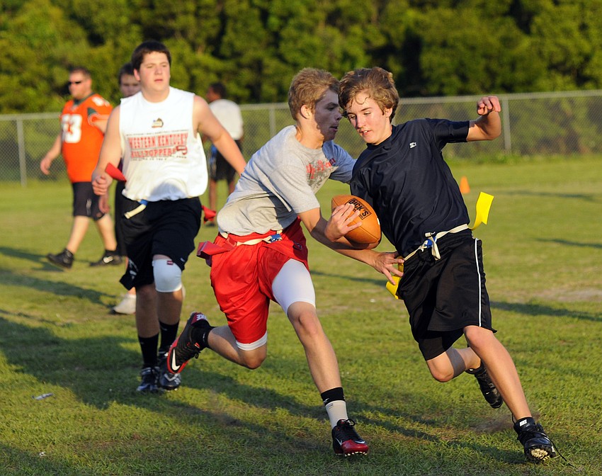 Eigth-grader Erik Ross attempts to stop seventh-grader Adam Zapatha from getting a first down.