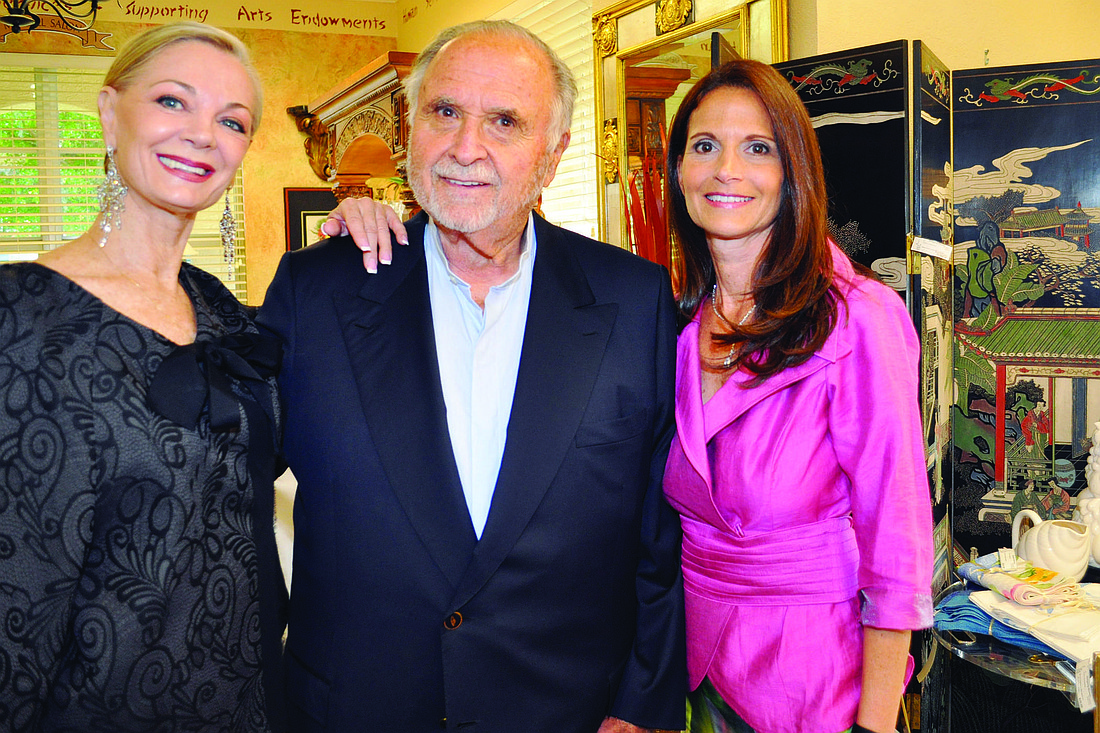 Designing Women Boutique founder Jean Weidner, Ronald Taub and Marcia Jean Taub, wearing one of her late mother's outfits.