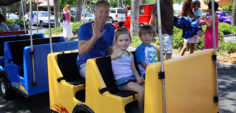 Keith Hagan along with his daughter Lianna Hagan and LT Hamilton get ready to go on a ride on the Royal Express on Sunday, April 17 during South Bay's Family Fun Day.