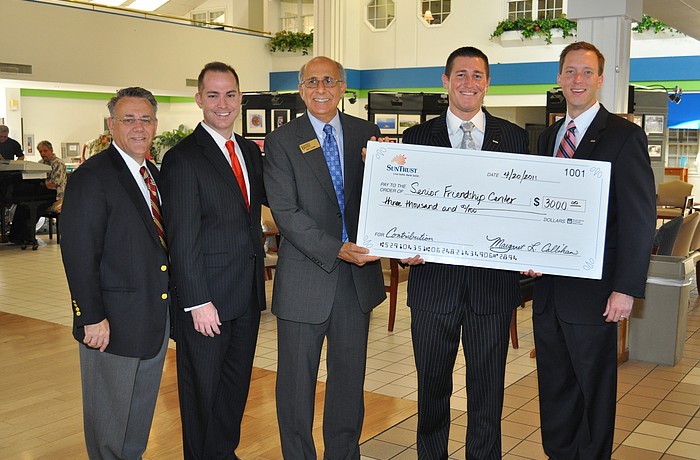 SunTrust Bank's Mike Lonas, Chris Tenaglia, Ryan Kern and Max Hannum present a $3,000 check to Senior Friendship Centers President and CEO Bob Carter.