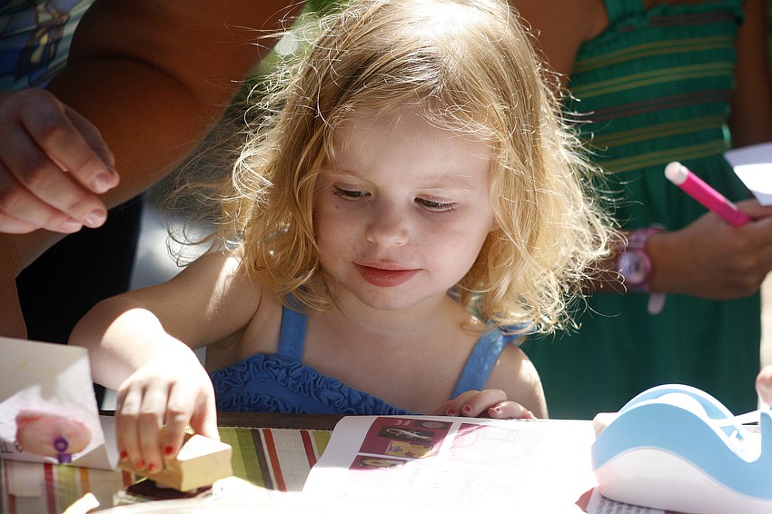 Olivia Carr, 2, created an Easter art project at the Main Street celebration.