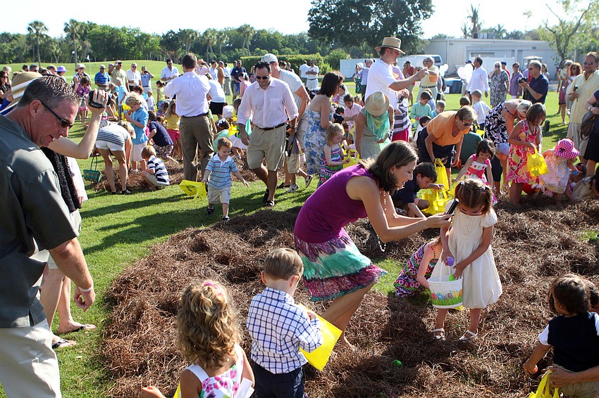 Kids scramble to find as many eggs as possible as their parents encourage them Sunday, April 24 at Longboat Key Club's Easter egg hunt.