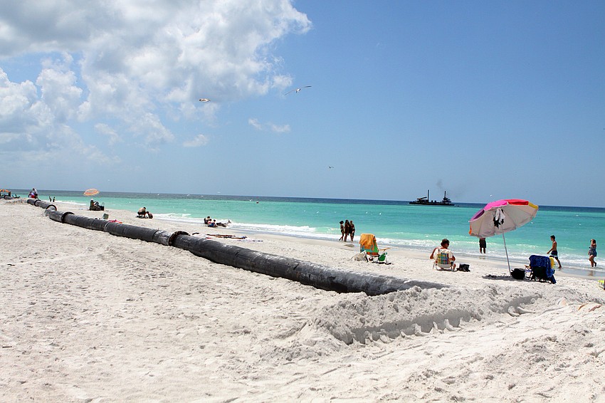 Beachgoers worked around the sand project pipeline in order to bask in the sun Monday, April 25. The pipeline is part of the emergency sand project on the north end of Longboat Key.