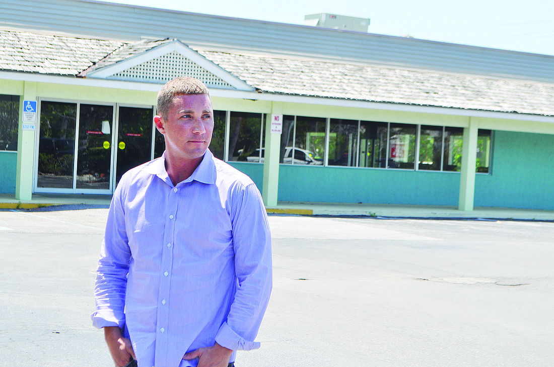 Brian Kenney stands in front of Whitney Beach Plaza, which is currently 85% vacant.