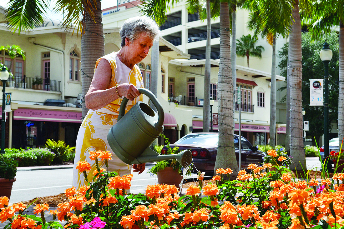 Eileen Hampshire tends to the colorful flowerbed in front of her store, Art to Walk On, as she has for the past five years. She has performed and funded all landscaping maintenance outside her front door.