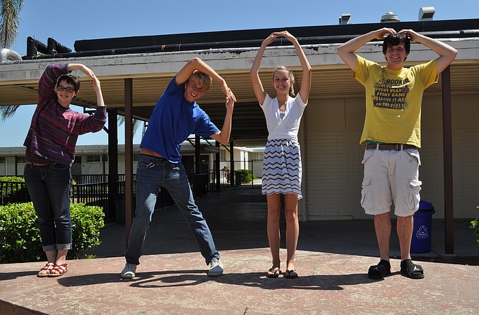 Booker High School junior advisory board members Sara Stolpe, Miles McCreery, Amanda Stambrosky and Kurt Hoffman spell out P-R-O-M.