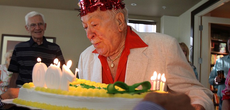 Walter Derdeyn blows out the candles on his cake during his 100th birthday party Friday, May 6 at the Regency House.