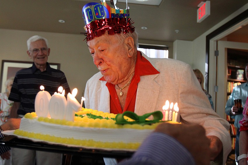 Walter Derdeyn blows out the candles on his cake during his 100th birthday party Friday, May 6 at the Regency House.