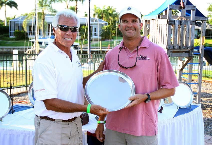 Commodore Bob Baime congratulates Dave Hillmyer for coming in 1st in the spinnaker division Saturday, May 7 in the Sarasota Bay Cup at Bird Key Yacht Club.