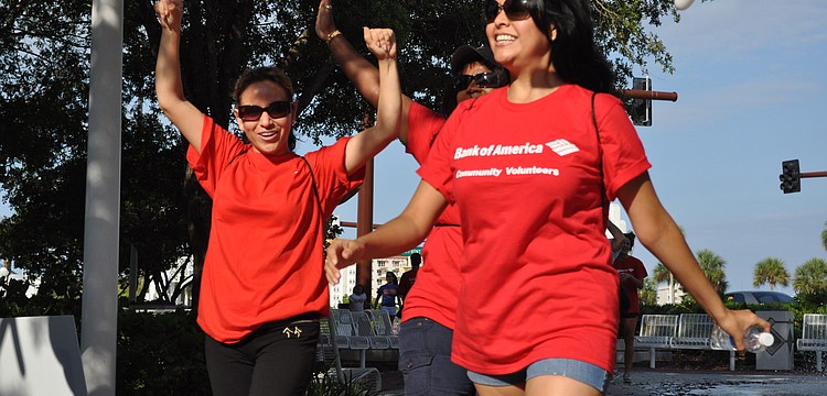 Cristina Chirinos and Zelideh Loredo are excited to walk through the finish line.