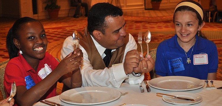 Daniel Valderrama gives Kierra Henderson and Nassim Ghaffari a lesson on proper utensil placement.