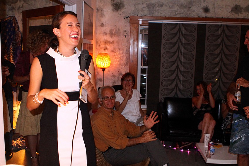 Alexis Orgera laughs and smiles at the warm reception she received from her peers at her book release party Saturday, May 14 at Red Panty Press Studio.