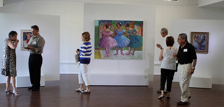 People make their way around the Durante Gallery looking at Fiore Custode's paintings at the opening of the RCAD Creatives Exhibition Thursday, May 19 at Longboat Key Center for the Arts.