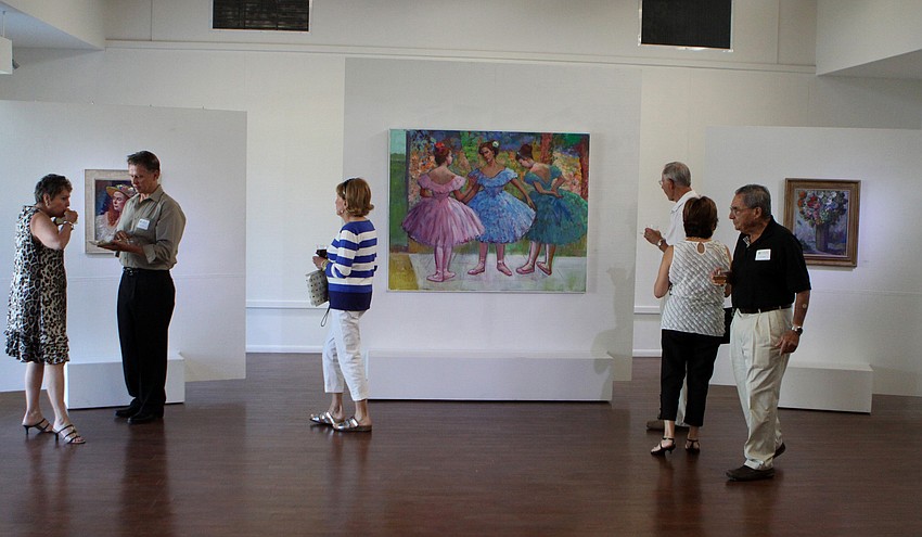 People make their way around the Durante Gallery looking at Fiore Custode's paintings at the opening of the RCAD Creatives Exhibition Thursday, May 19 at Longboat Key Center for the Arts.
