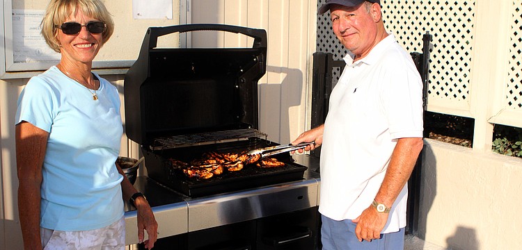 Jackie and Stu Tauber were in charge of the grill at Harbour Circle's End of Season BBQ Sunday, May 22 at the pool.