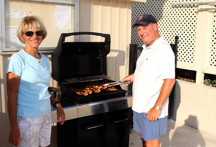Jackie and Stu Tauber were in charge of the grill at Harbour Circle's End of Season BBQ Sunday, May 22 at the pool.
