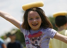 Paris Fauquet, 6, cooled off by balancing a cold, wet sponge on top of her head.