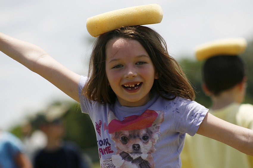 Paris Fauquet, 6, cooled off by balancing a cold, wet sponge on top of her head.
